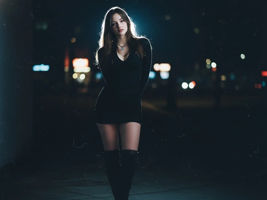 Blue-hour street portrait with neon backlight